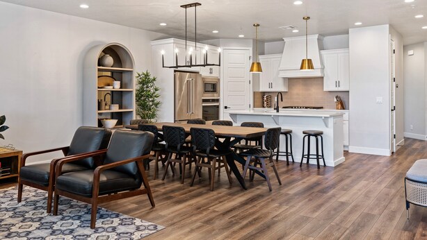 A modern kitchen with white cabinets, a wooden dining table, and black chairs. - Desert Escape- Private Hot Tub! Book with next door unit! (Washington)