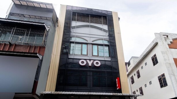 A building with a prominent 'OYO' sign on the facade. - OYO 3159 Festive Inn (Medan)