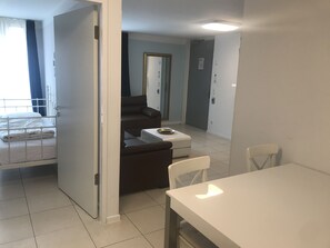 Family Suite | Living area | TV, heated floors