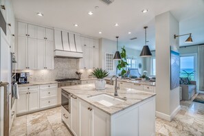 Enjoy cooking in this well-lit kitchen with a large island, sink, and ample counter space.