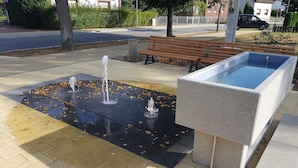 A public square with a water feature, benches, and a paved area. - Blooming vacation home at Scharmützelsee (Wendisch Rietz)