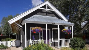 A house with a gabled roof, a porch with white railings, and a number '305' on the front. - 305 Third Street (Crested Butte)