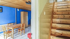 A room with a wooden table and chairs, a blue wall, and a white radiator. - 2 bedroom pet friendly home in Legbad (Legbad)