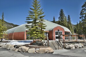 A building with a curved roof, a sign reading 'Warren Station at Keystone,' and a staircase leading to the entrance. - On River Trail! Walk to Festivals, Dining, Shops. Hot Tub, Sauna! (Keystone)