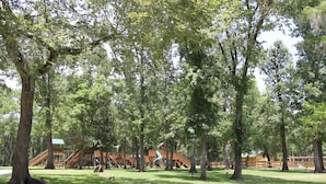 A park with wooden structures, including a playground and a covered area. - Family Vacation Cabin C3 (Cleveland)