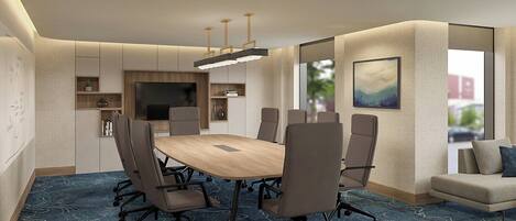 A modern conference room with a large table, multiple chairs, a television, and a sofa.