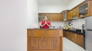 A kitchen with wooden cabinets, a central island, and modern appliances.