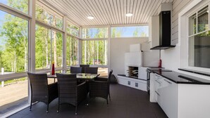Una cocina moderna con comedor, ventanas amplias y vistas al exterior.