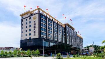 A multi-story hotel with a modern facade, large windows, and a flat roof.