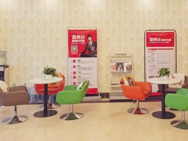 A hotel lobby with modern chairs, small tables, and informational posters on the walls. - Greentree Inn Danyang Danbei Town Xinqiao (Zhenjiang)