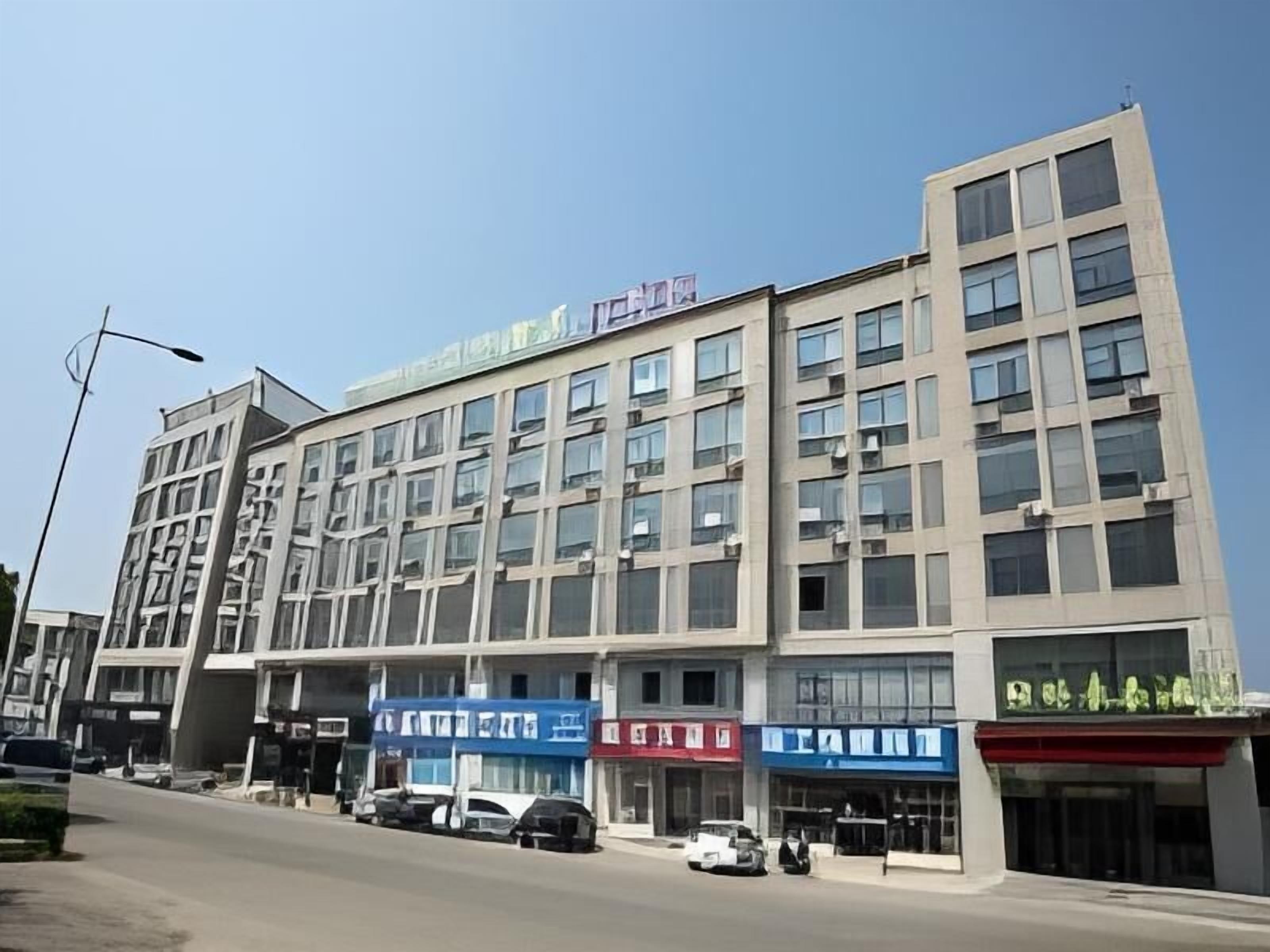 Un edificio comercial de varios pisos con amplias ventanas y fachada plana.