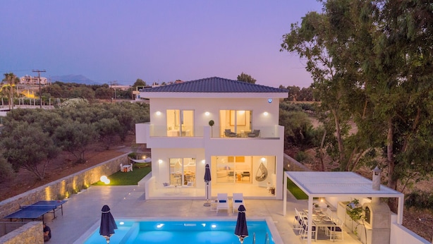 A modern two-story house with a swimming pool, outdoor seating, and a view of the surrounding landscape. - Constantinos Villa, Sublime Island Εscape.Walking distance to the beach & shops (Panormos in Rethymno)