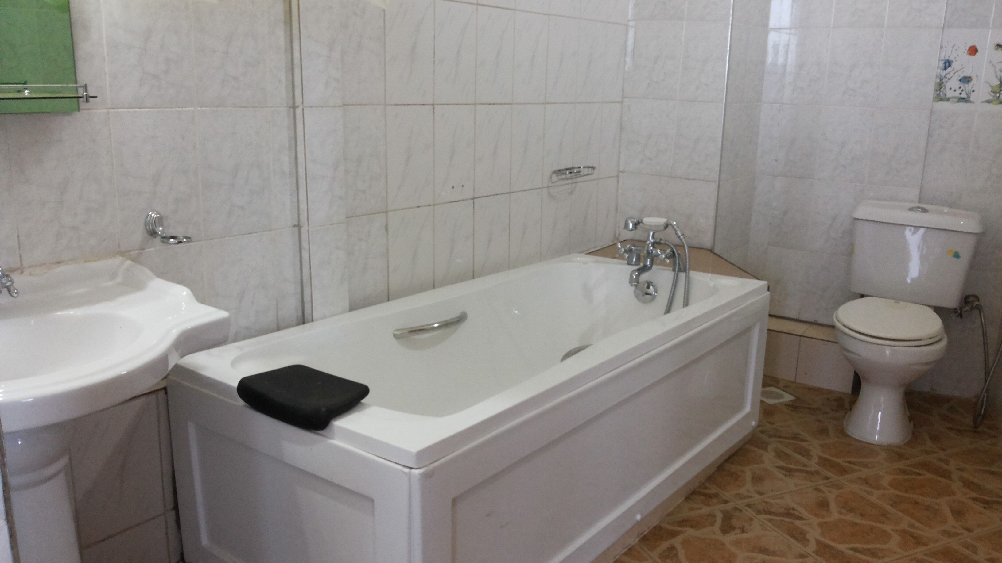 A bathroom with a bathtub, a sink, and a toilet.