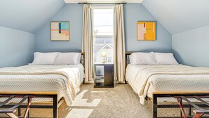 A bedroom with two beds, a window with curtains, and artwork on the walls. - 1 Mi to Dtown & Lucas Oil Stadium: Fenced Yard (Indianapolis)