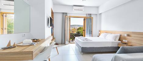 A modern hotel room with a bed, a desk, a chair, and a balcony with a view.