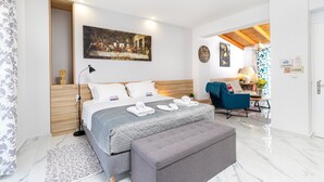 A modern bedroom with a large bed, a desk, and a chair.