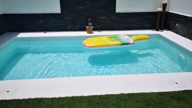 A swimming pool with a floating mat, a Buddha statue, and candles. - PRIVATE GARDEN & HEATED POOL, WIFI Fiber 600Mb / s Total comfort and total privacy (La Oliva)