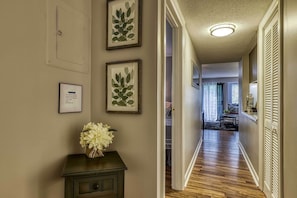 Stunning hallway leads to a cozy living area with a sofa and coffee table.