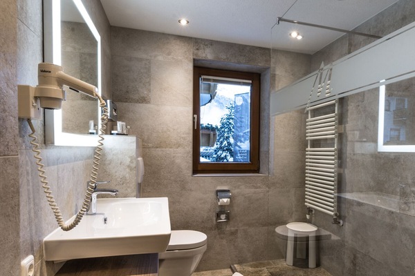 Shower, hair dryer, slippers, towels