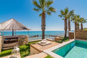 Outdoor pool, sun loungers - Uranus Deluxe SeaFront Villa, a Secluded Gem  (Drosia)