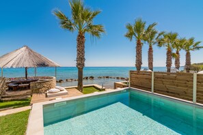 Outdoor pool, sun loungers - Uranus Deluxe SeaFront Villa, a Secluded Gem  (Drosia)