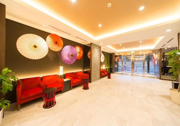 Welcome to our lobby, featuring a reception area, comfortable seating, and vibrant decor.