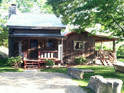 1800’s restored log cabin on 26 private rolling wooded acres with sunset views
