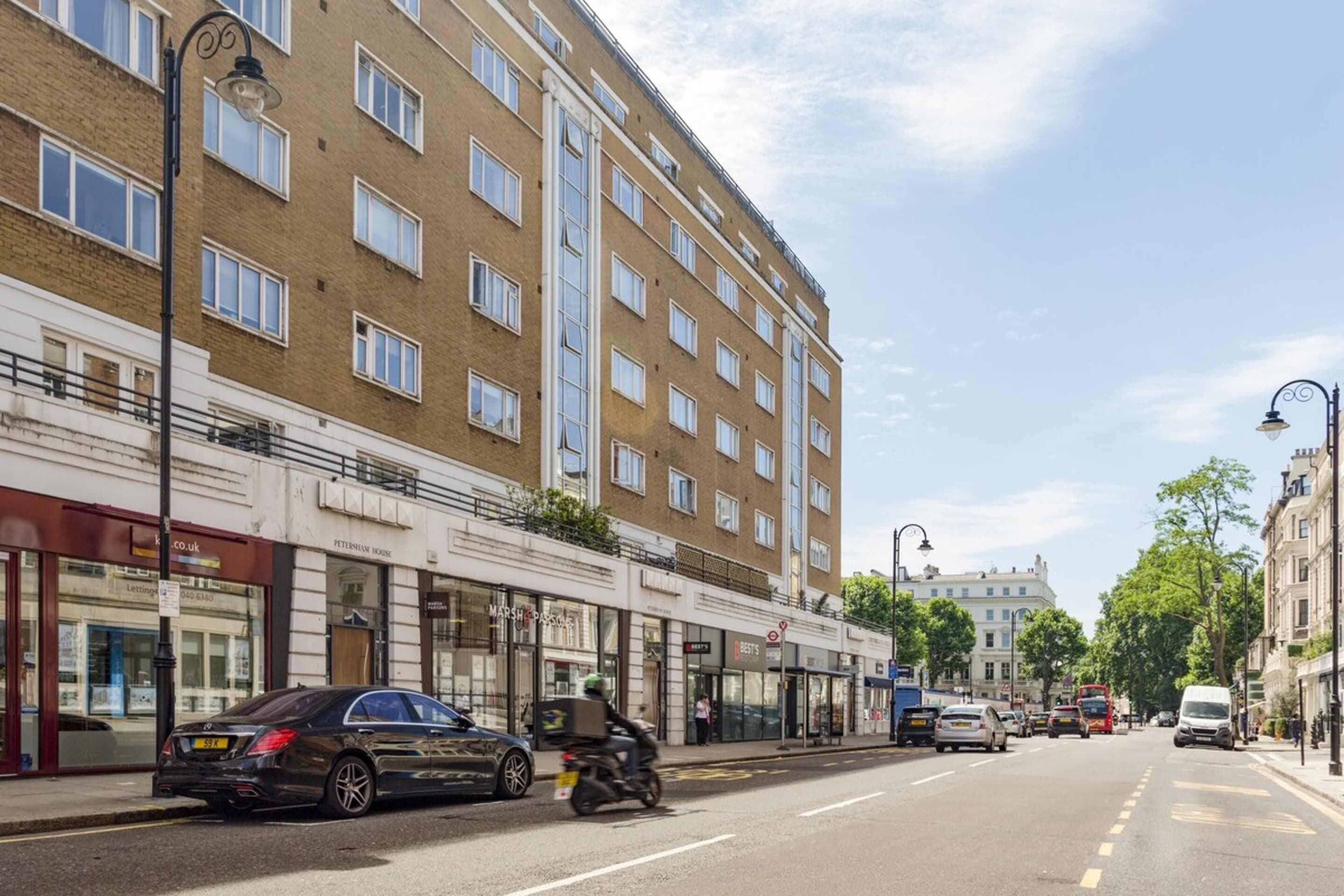 A street view with a row of shops, including a pet store and a restaurant.