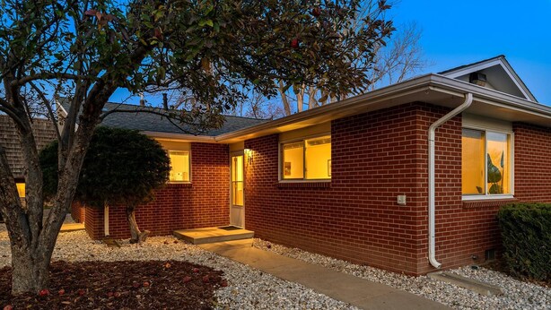 A brick house with a front porch, a tree, and a well-maintained lawn. - Hidden Gem Near Old Town, BBQ & Bikes!! (Fort Collins)