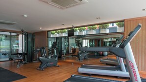 A gym with treadmills, elliptical machines, and weight equipment.
