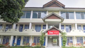 A two-story building with a central entrance, multiple windows, and a sign for 'OYO'. - OYO 3250 Setia Hotel (Cipanas)