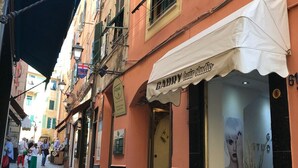 A narrow street with a row of buildings, one with a white awning labeled "GABPY hair studio". - PRETTY AND VERY CENTRAL ATTIC ONE STEP FROM THE SEA (Varazze)