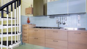 A kitchen with a gas stove, sink, and cabinets. - Adriana Sicily House Etna & Sea air Conditioner Check in 24H (Acireale)