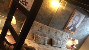A cozy room with a bed, a chair, and a sign that reads "WAR IS OVER!". - Loft In Merida For Five (Mérida)