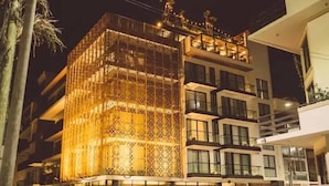 A modern hotel with a distinctive facade featuring a lattice structure and multiple balconies. - It Residence, 2 Bedroom Apartment with Rooftop Pool (Playa del Carmen)