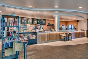 Enjoy a warm and inviting atmosphere at this café, featuring a curved counter and comfortable seating options.