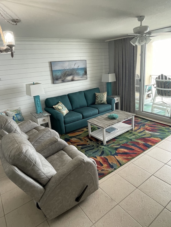 Relax in this inviting living space with a comfortable sofa, armchair, and coffee table.