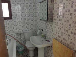 A bathroom with a toilet, sink, and mirror. - Cortijo La Huerta Private Pool (Alcala la Real)