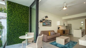A modern apartment with a living area, kitchen, and balcony. - Lovely One Bedroom With Amazing Terrace View!! (Playa del Carmen)