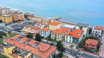 A coastal town with colorful buildings, a beach, and a view of the sea.