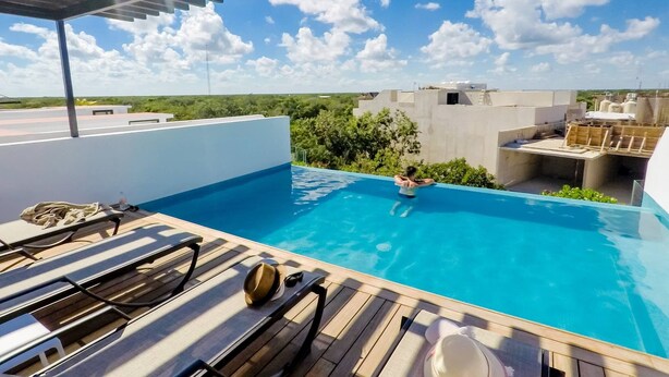A rooftop pool with sun loungers and a clear view of the sky. - Brand New Two Br Penthouse With a Private Roof Patio! Totally Equipped (Tulum)