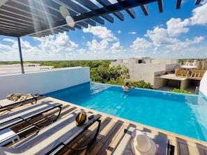 A rooftop pool with sun loungers and a clear view of the sky. - Brand New Two Br Penthouse With a Private Roof Patio! Totally Equipped (Tulum)