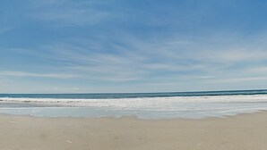 A beach with a clear sky and calm sea. - Private Beach House with amazing views of Shwan Lake and Twin Lakes Beach (Santa Cruz)