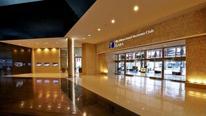 A modern hotel lobby with a clean, polished floor and a well-lit entrance to the Hilton Grand Vacations Club.