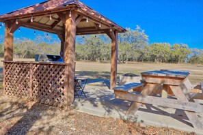 Enjoy al fresco dining in this charming gazebo with a grill.