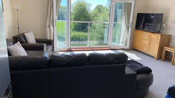 Apartment, 2 Bedrooms, River View | Living area | TV