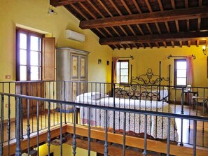 A bedroom with a bed, a wardrobe, and a window.