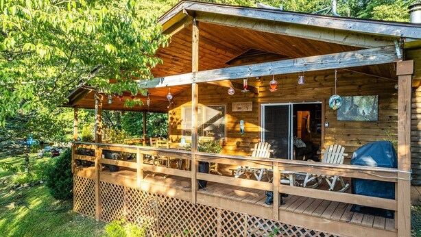 A wooden cabin with a covered porch, outdoor seating, and a barbecue area. - 4 Cabins/Mountain Views /Jacuzzi/Wi-Fi/Large Groups (Whittier)