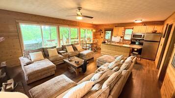 A cabin interior with a living area, dining space, and kitchen.