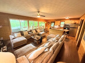 A cabin interior with a living area, dining space, and kitchen.